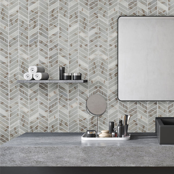 Simple Stone Oro chevron glass mosaic conveying a bold, graphic movement with its warm oro gold tone and dynamic V-shaped glass pattern