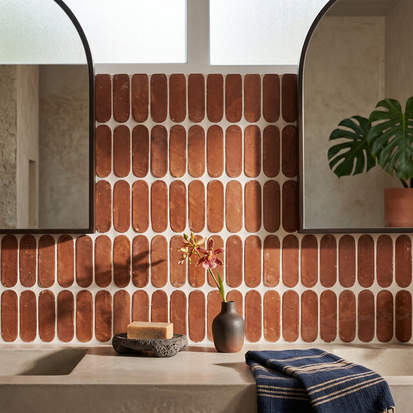 Zellige Bespoke Sundried Clay 2x6 long oval glossy terracotta subway hand cut tile conveying a unique artisan character with its earthy sundried clay tone and distinctive oval form
