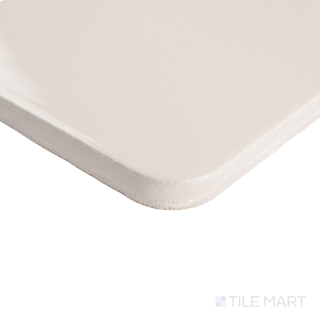 Corner detail of Curves Halo Ivory 6x6 glossy ceramic tile, highlighting its smooth edges and soft ivory finish with a sleek reflective surface