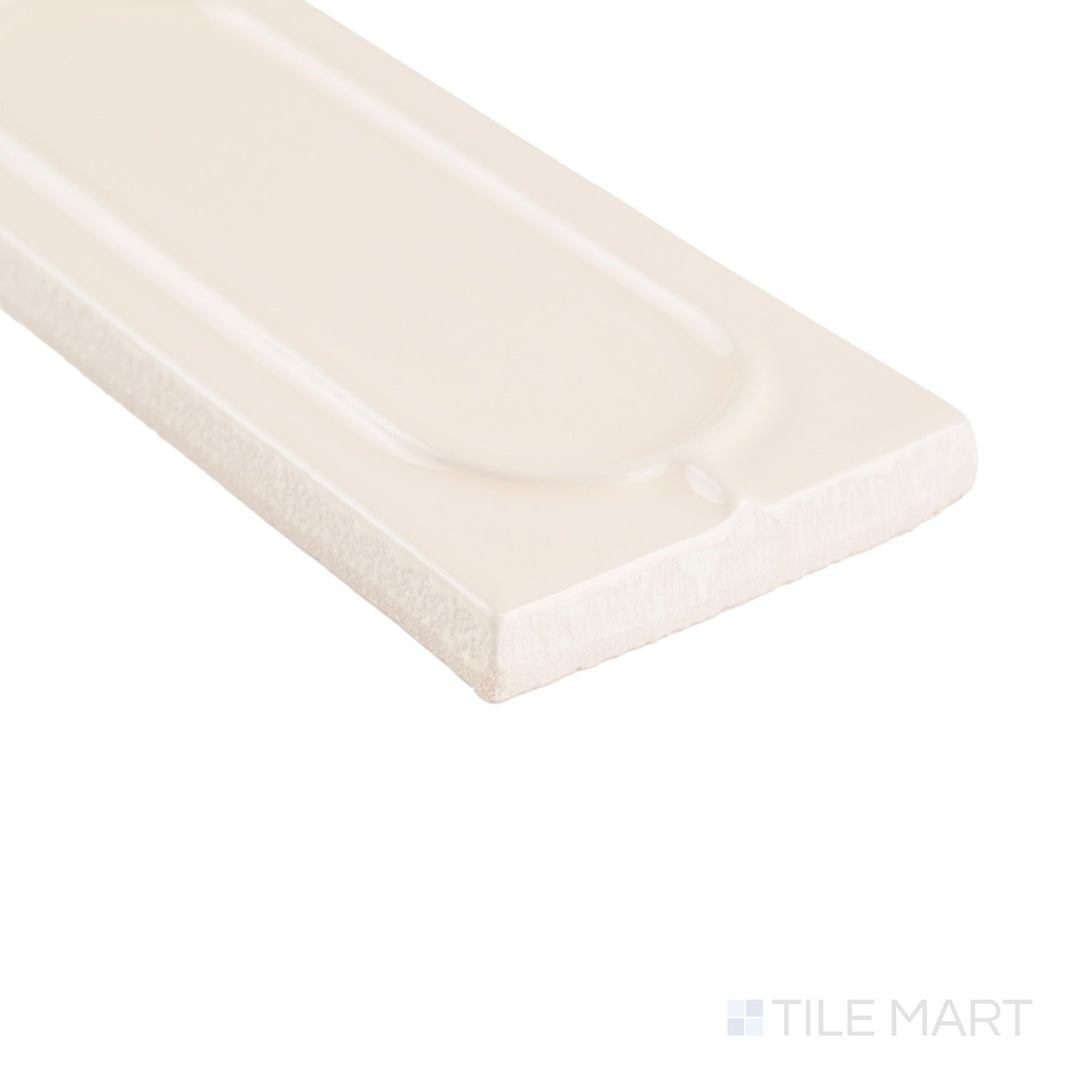 Corner close-up of Curves Sophee Ivory 2.5x6 glossy ceramic tile, featuring a warm ivory tone and smooth, polished edge