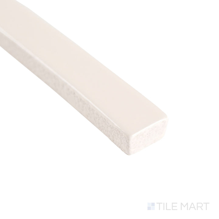 Corner detail of Curves Ivory 5/8x6 glossy ceramic pencil tile, showcasing its glossy ivory glaze and precise edge line