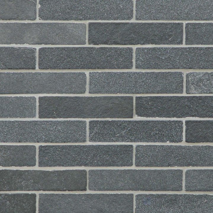 Meshed Lime Black thin brick limestone mosaic with a tumbled finish and natural stone texture