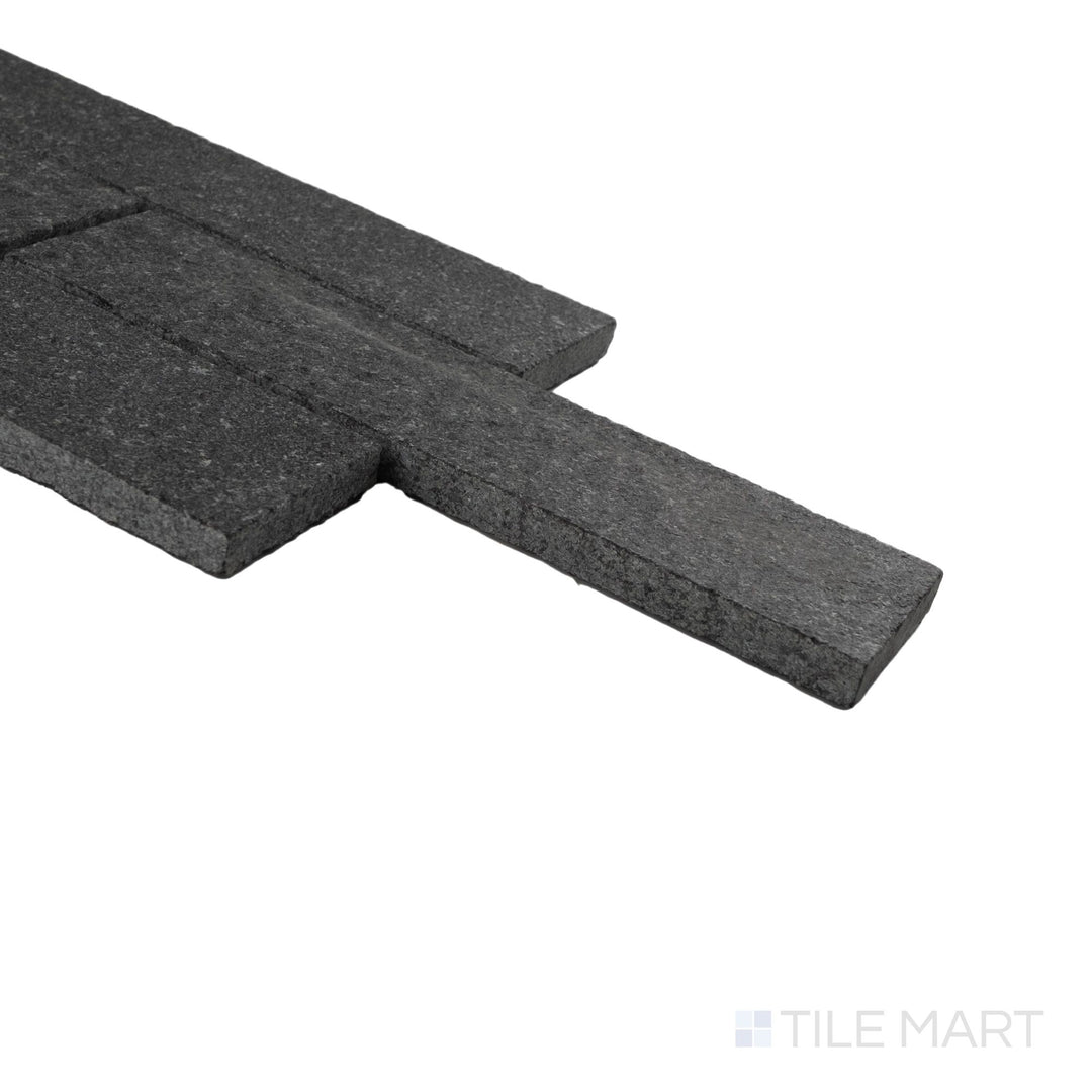 Corner view of meshed Lime Black thin brick limestone mosaic highlighting tumbled texture and layered stone depth