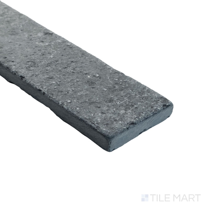 Loose Lime Black 2x8 thin brick limestone shown in corner view with worn edges and organic texture