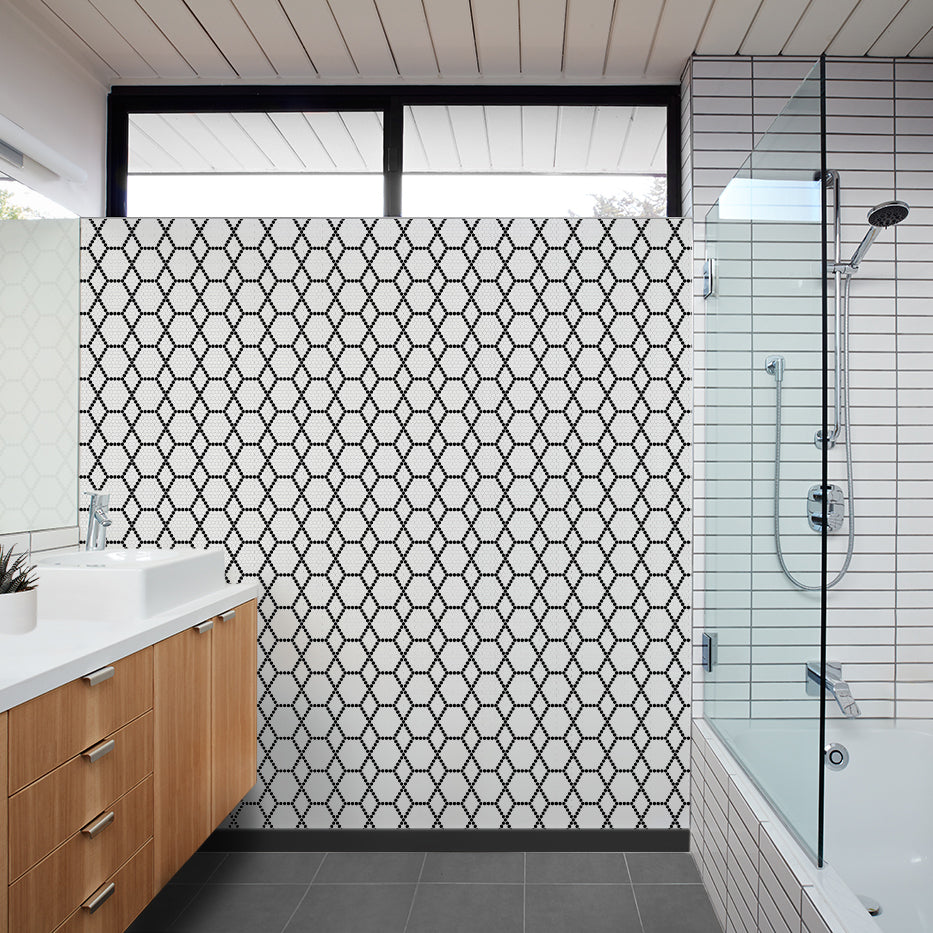 A real-life view of Geometro Tulle Classic 3/8" hexagon matte recycled glass mosaic, adding depth and character to the room with its sophisticated geometric arrangement.