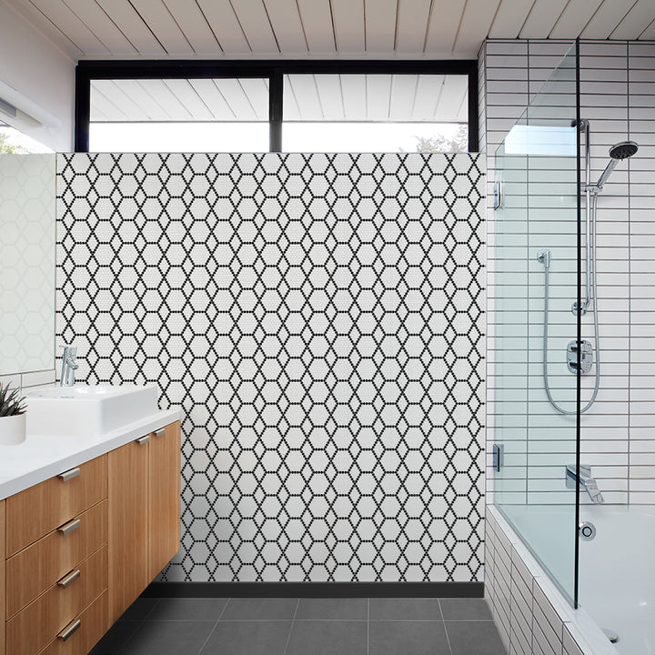 A real-life view of Geometro Tulle Classic 3/8" hexagon matte recycled glass mosaic, adding depth and character to the room with its sophisticated geometric arrangement.