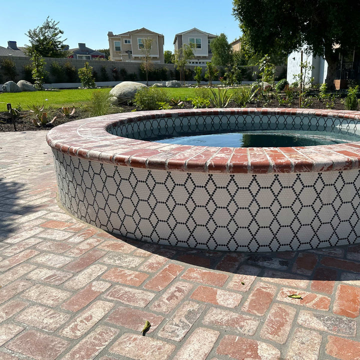 A refined hexagonal pattern in soft neutral tones with a matte finish adds geometric elegance, showcasing Geometro Tulle Classic 3/8" hexagon matte recycled glass mosaic.