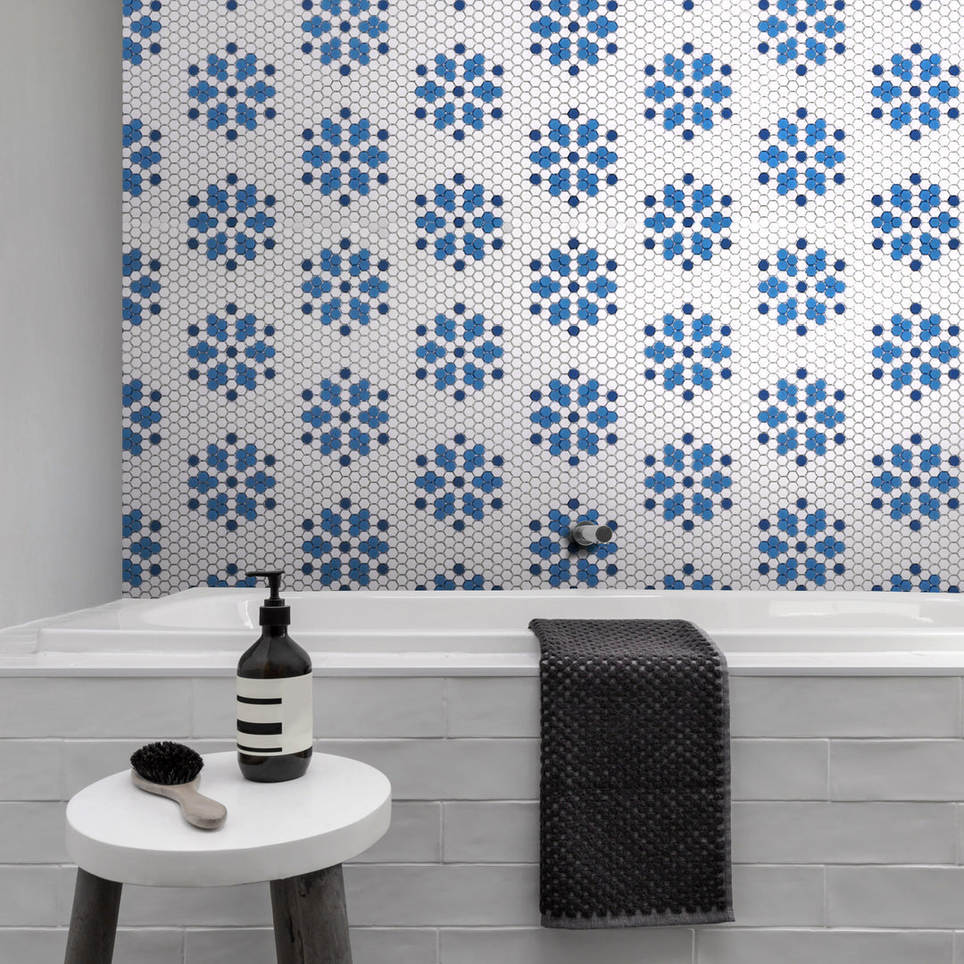 Coastal-inspired hues and a matte hexagon design bring a breezy, relaxed elegance to the space, beautifully styled with Geometro Bayeux Coastal 3/8" hexagon matte recycled glass mosaic.