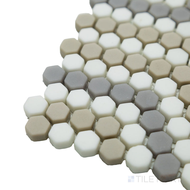 A close-up corner perspective reveals the natural tones and structured hexagonal layout of the Geometro Belfort Country 3/8" hexagon matte recycled glass mosaic, ideal for refined interiors.