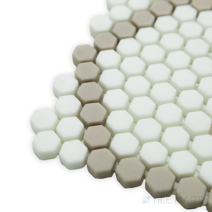 Soft natural color variations and a refined hexagonal layout stand out in this close-up corner view of the Geometro Tulle Country 3/8" hexagon matte recycled glass mosaic.
