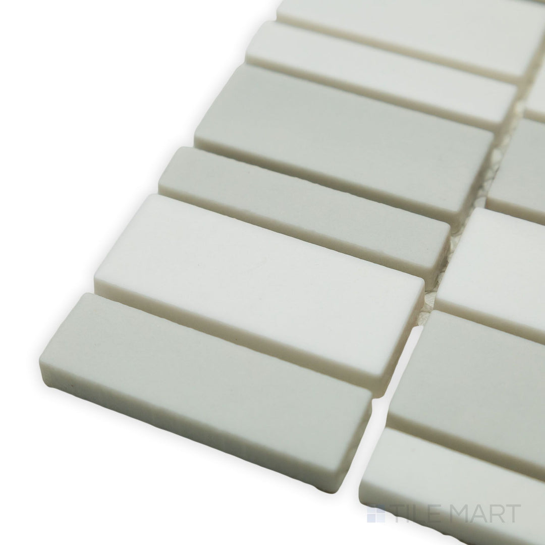 A creative arrangement of geometric shapes defines this corner shot of the Geometro Barcode Puzzle Rectangle matte recycled glass mosaic, offering a bold, modern aesthetic.