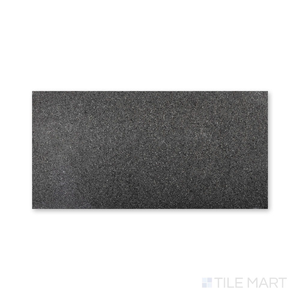 Top-down view of Absolute Black Granite 12x24 tile with a flamed finish, showcasing a rugged, textured black surface ideal for slip resistance.