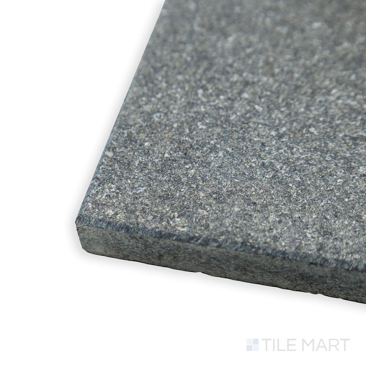 Corner close-up of Absolute Black Granite 12x24 flamed tile showing textured surface and deep black tone.