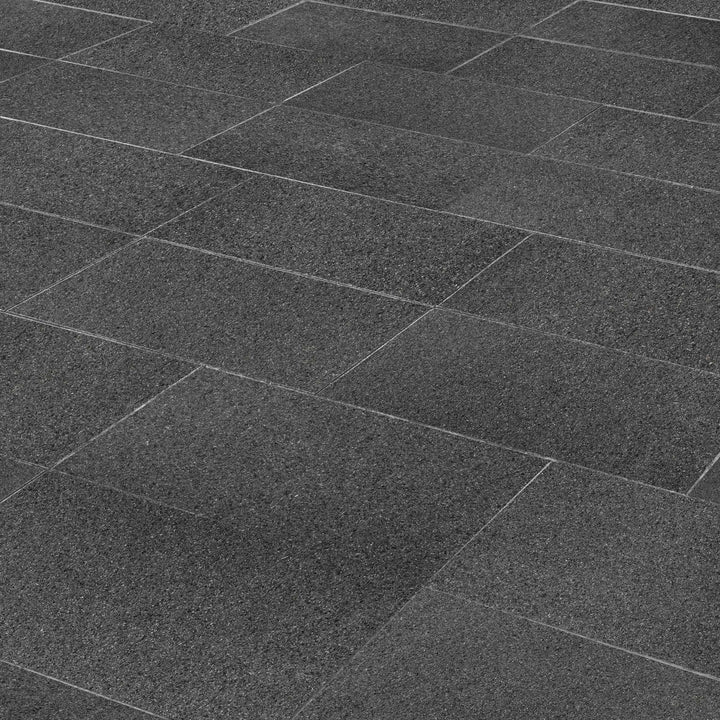 A deep black granite with a flamed texture, Absolute Black Granite 18x36 adds durability and a bold, modern appeal.
