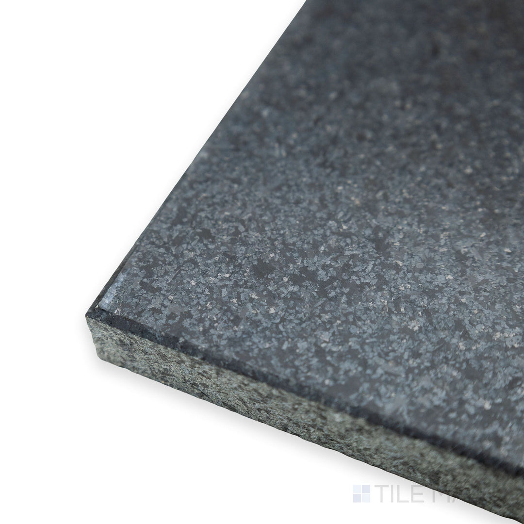 A sleek corner view of Absolute Black Granite 24x24 honed tile showcases its smooth, matte surface and uniform black finish, ideal for contemporary designs.