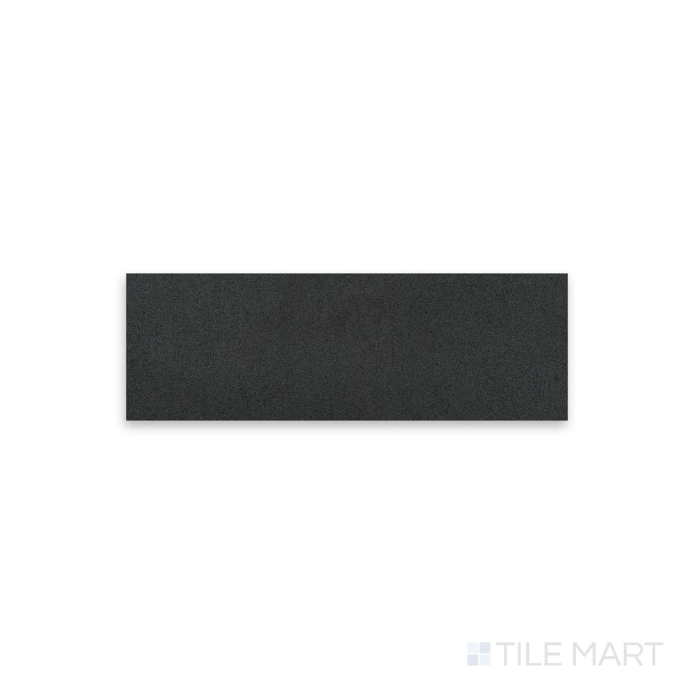 Top-down view of Basalt Black 4x12 honed tile, displaying a smooth, deep charcoal surface with fine-grain texture and a matte finish.