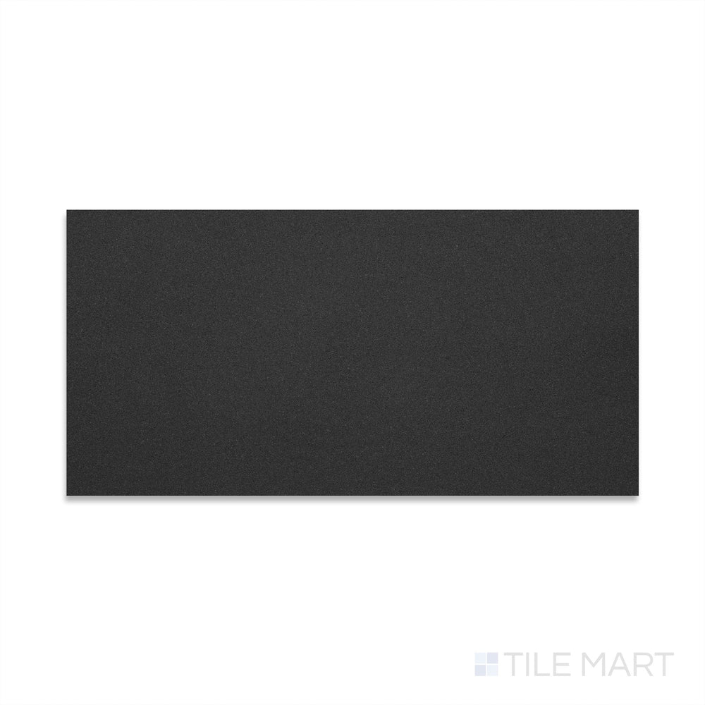 Flat-lay image of Basalt Black 12x24 honed tile, featuring a dark grey to black surface with a velvety matte sheen and minimal visual variation.
