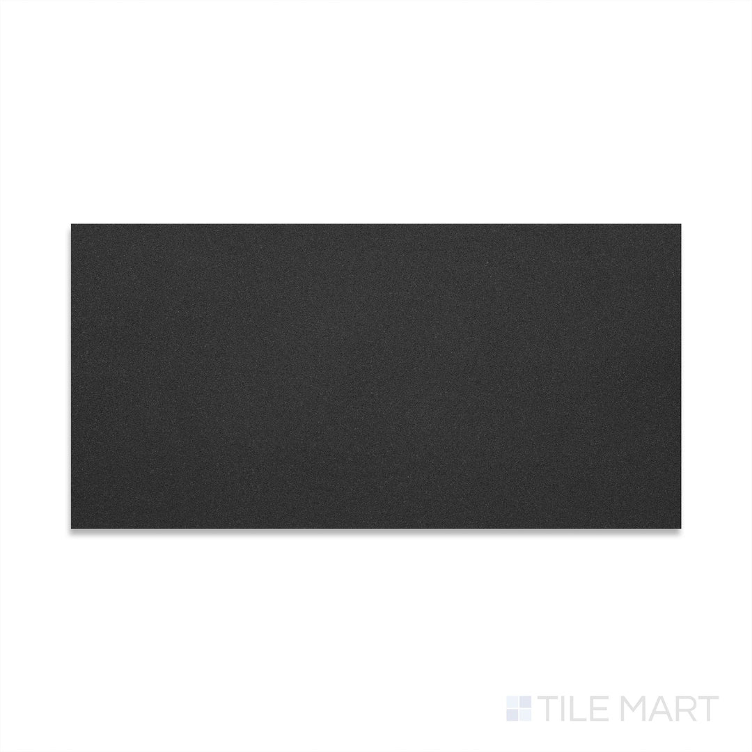Flat-lay image of Basalt Black 12x24 honed tile, featuring a dark grey to black surface with a velvety matte sheen and minimal visual variation.