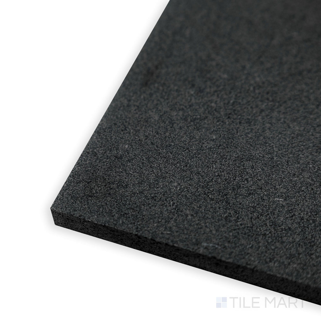 Corner detail of Basalt Black 12x24 honed tile highlighting fine-grained texture and rich deep black tone.