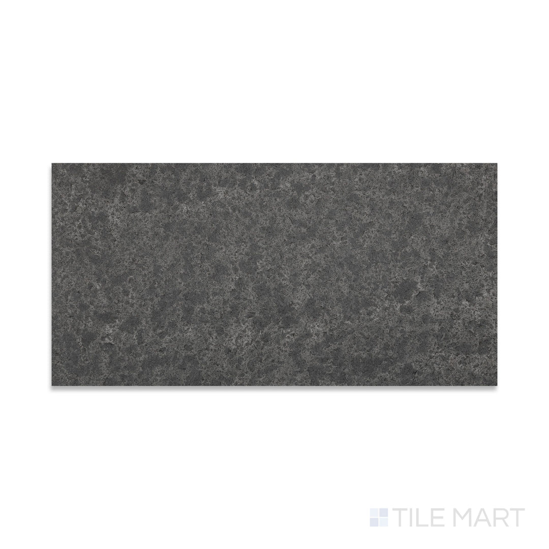 Close-up of flamed and brushed Basalt Black 12x24 tile showing textured surface and deep tonal depth