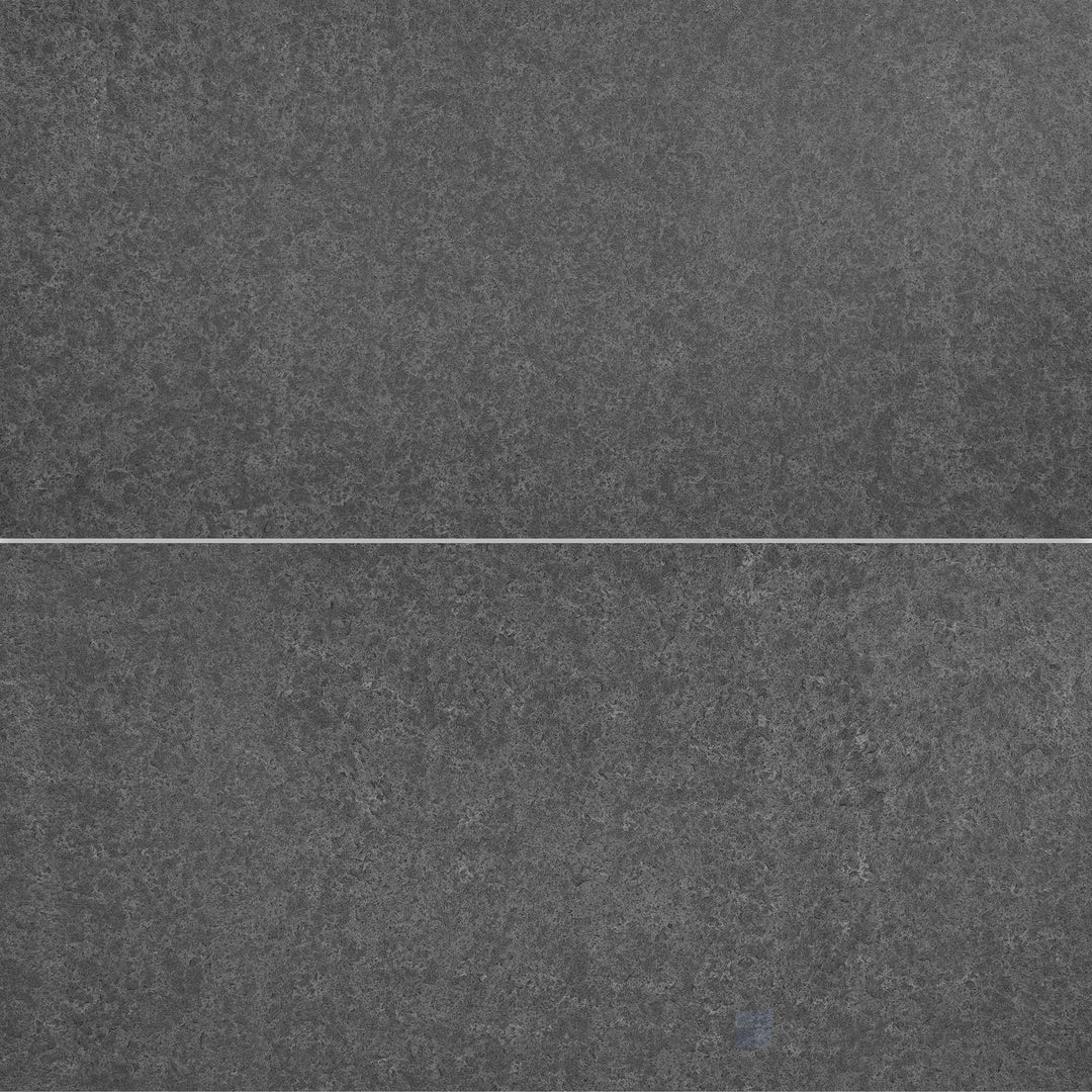 Flat-lay shot of Basalt Black 18x36 flamed and brushed tile, combining a textured and brushed finish for a unique rustic appeal.