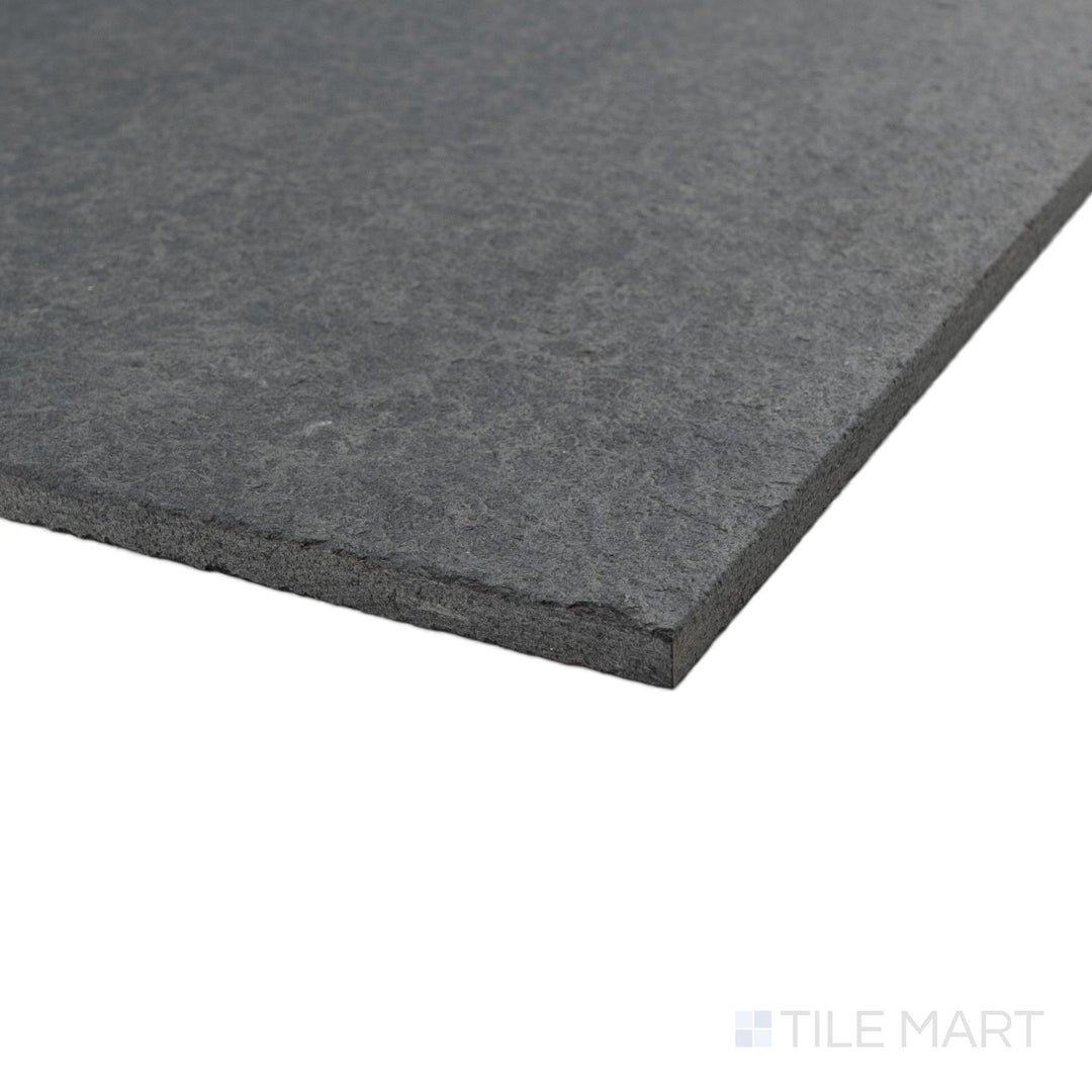 Basalt Black 18x36 tile in corner view showcasing flamed and brushed texture with bold linear scale