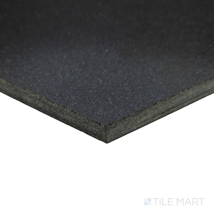 A bold geometric design comes to life in this corner shot of Basalt Black 10" hexagon honed tile, highlighting its sharp angles and smooth stone finish.