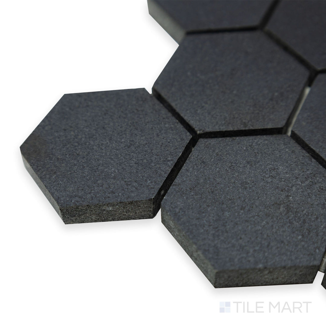 A detailed corner shot of Basalt Black 2" hexagon honed mosaic emphasizes its intricate hexagonal pattern and the subtle honed texture of natural basalt.