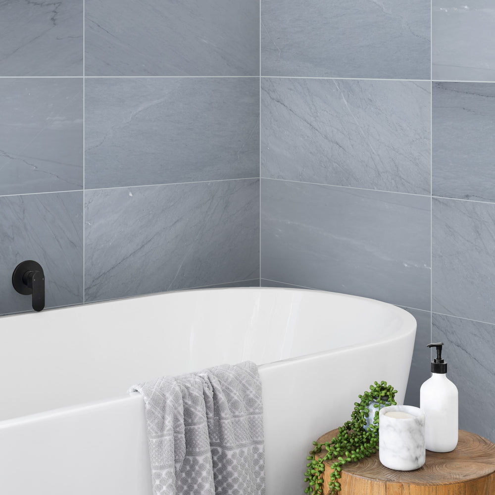A luxurious modern roomscene featuring Bardiglio Imperiale Bluish Grey 12X24 Honed Marble, enhancing the space with its rich veining and soft matte finish.