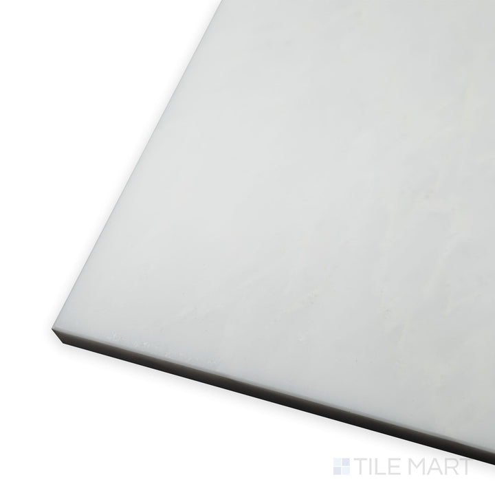 A polished surface reflects soft lighting in this corner shot of Oriental White Marble 3x6 polished tile, emphasizing its elegant white tones.