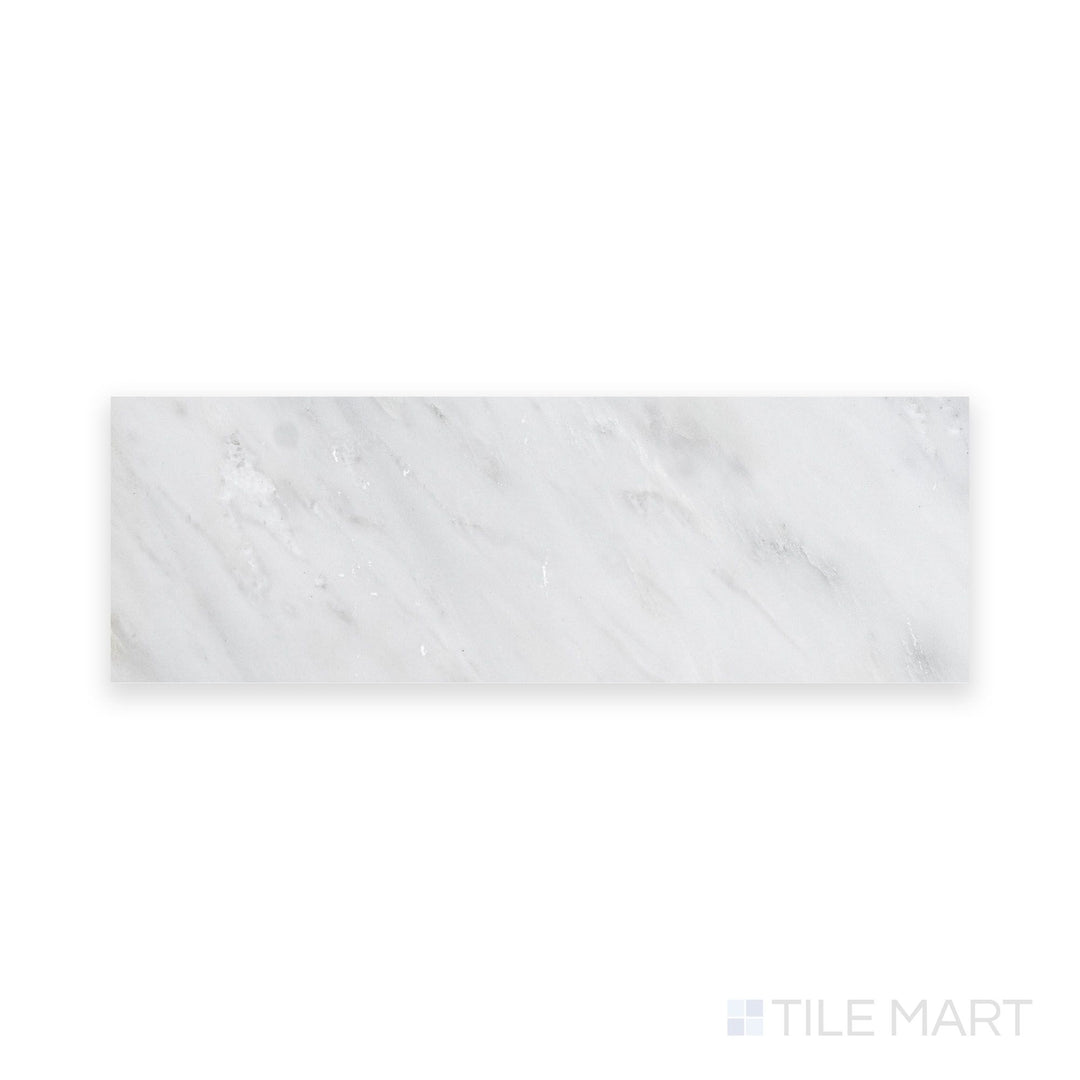 Intricate details of Oriental White Marble 4X12 Honed, revealing its matte texture and graceful color variations.