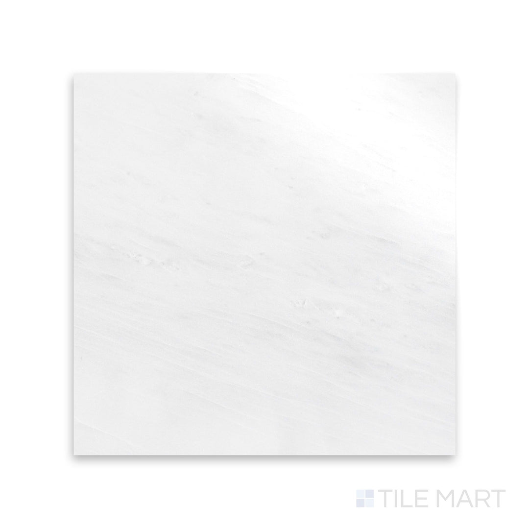 An up-close perspective of Oriental White Marble 12X12 Polished, showing its glossy texture that enhances the depth of its veining.