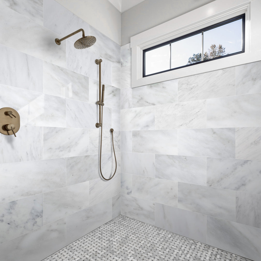 A contemporary and light-filled room featuring Oriental White Marble 12X24 Honed, demonstrating how large-format marble tiles create an airy, seamless effect.
