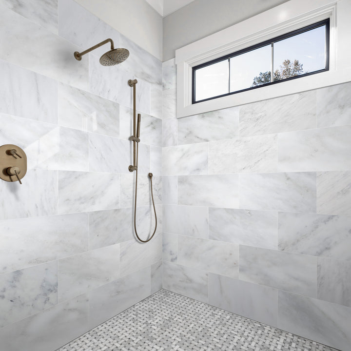 A contemporary and light-filled room featuring Oriental White Marble 12X24 Honed, demonstrating how large-format marble tiles create an airy, seamless effect.