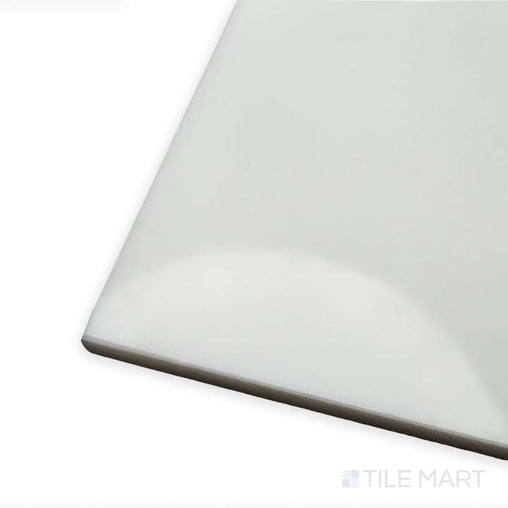 With light reflecting from a polished surface, this diagonal corner shot of Oriental White Marble 24x24 polished tile showcases its luxurious white background and delicate veining.