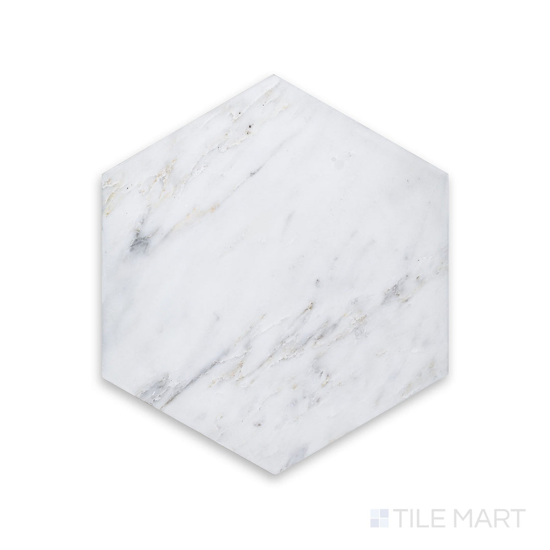 A close-up of Oriental White Marble 6" Hexagon Honed, showcasing its soft, matte finish and intricate veining.
