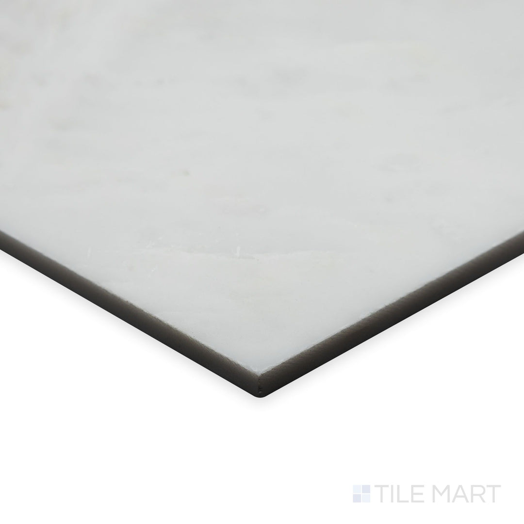 An angled corner view captures the glossy finish of Oriental White Marble 6" hexagon polished tile, emphasizing its radiant sheen and pristine white marble tones.