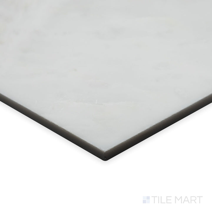 An angled corner view captures the glossy finish of Oriental White Marble 6" hexagon polished tile, emphasizing its radiant sheen and pristine white marble tones.