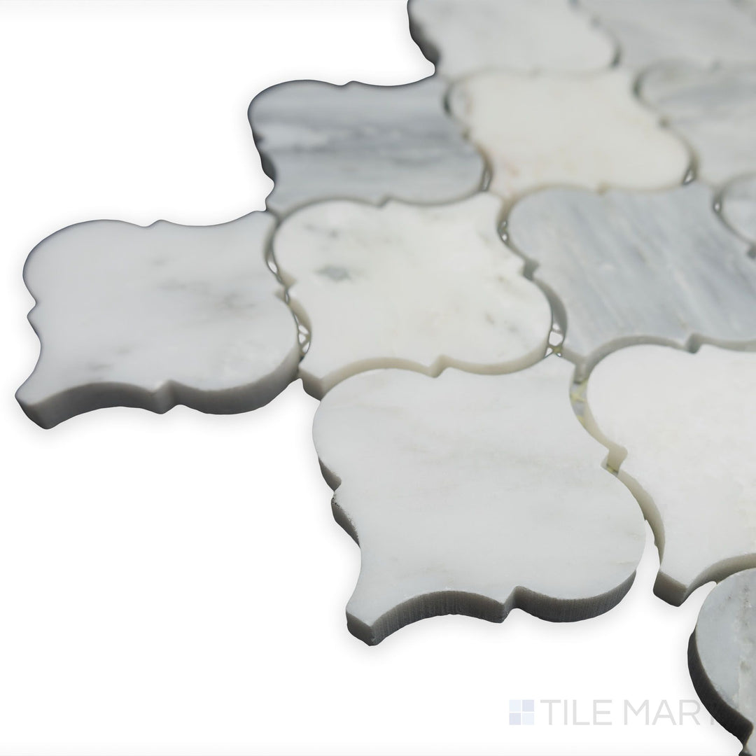 A close-up corner perspective showcases the elegant curves of Oriental White Marble 3" lantern/arabesque honed mosaic, where its soft matte texture adds a timeless charm.