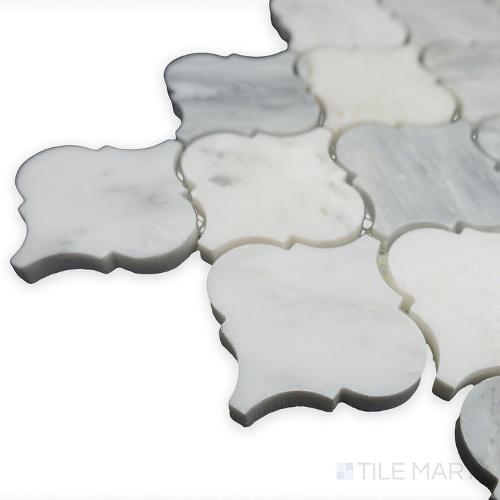 A close-up corner perspective showcases the elegant curves of Oriental White Marble 3" lantern/arabesque honed mosaic, where its soft matte texture adds a timeless charm.
