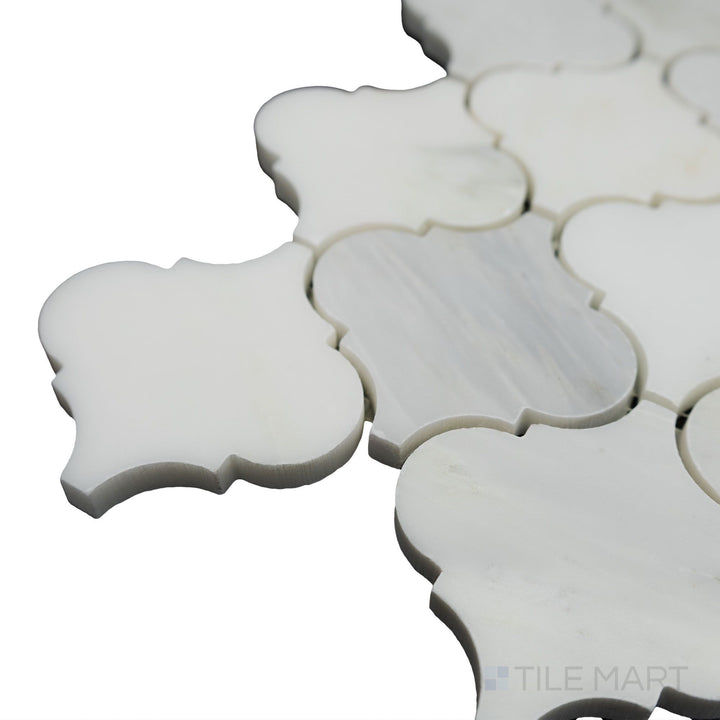 From a well-lit corner shot, the Oriental White Marble 3" lantern/arabesque polished mosaic highlights its high-gloss surface and intricate arabesque design for a refined touch.