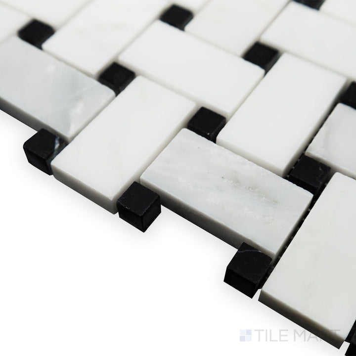 A detailed corner angle captures the contrasting elegance of Oriental White Marble basketweave with black dot honed mosaic, where its matte finish enhances the striking pattern.