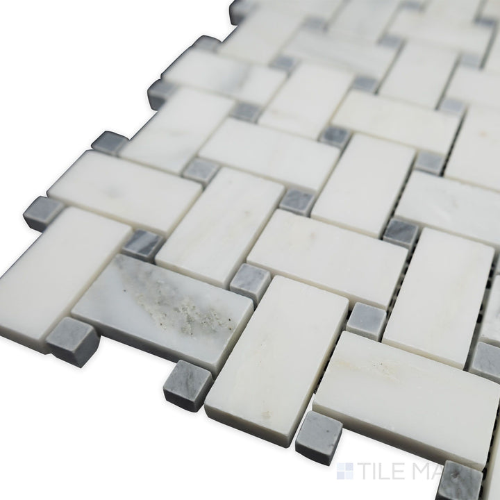 A unique blend of contrast and geometry is showcased in this corner shot of Oriental White Marble basketweave with blue dot honed mosaic, balancing subtle color and classic style.