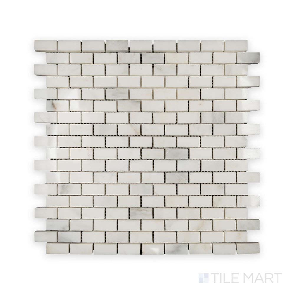 A detailed look at Oriental White Marble 5/8X1-1/4 Brick Polished Mosaic, reflecting light beautifully across its polished surface.