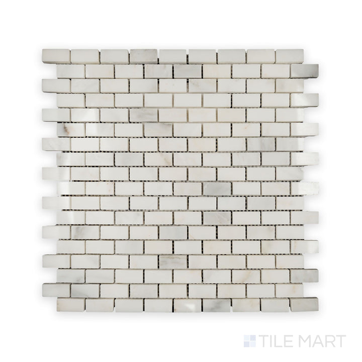 A detailed look at Oriental White Marble 5/8X1-1/4 Brick Polished Mosaic, reflecting light beautifully across its polished surface.