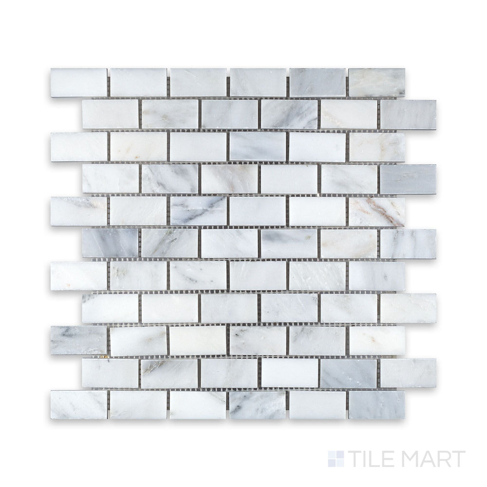 An up-close perspective of Oriental White Marble 1X2 Brick Honed Mosaic, bringing out its subtle texture and natural stone variation.