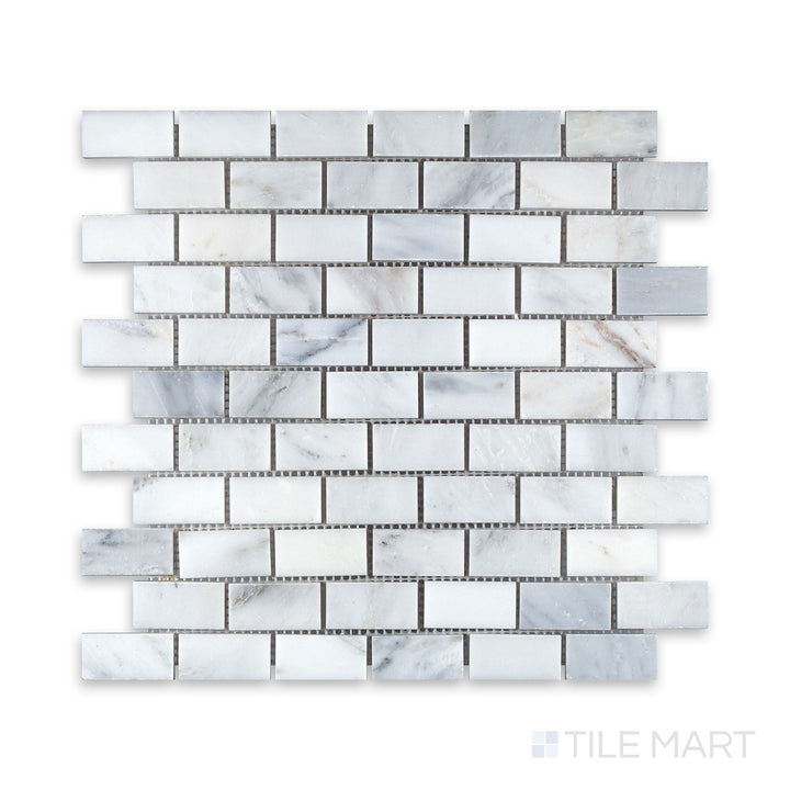An up-close perspective of Oriental White Marble 1X2 Brick Honed Mosaic, bringing out its subtle texture and natural stone variation.