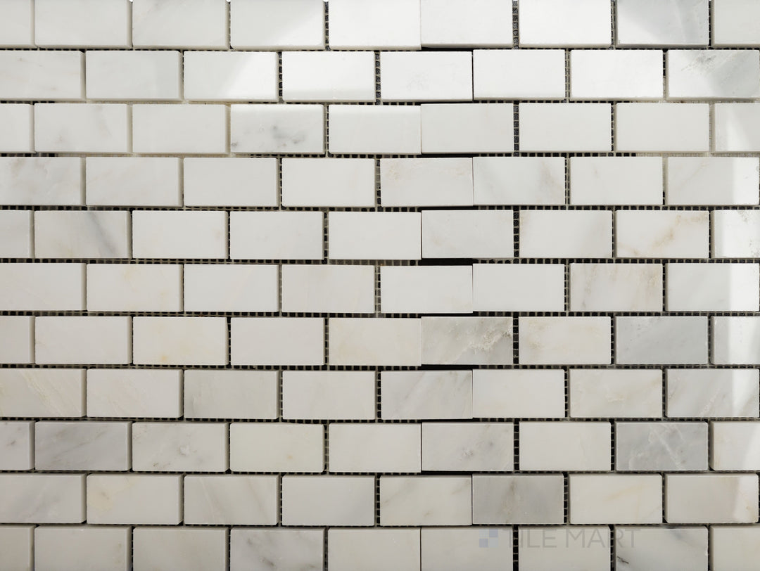 Flat-lay shot of Oriental White Marble 1x2 brick polished mosaic, showcasing a sleek polished finish that highlights the natural veining.