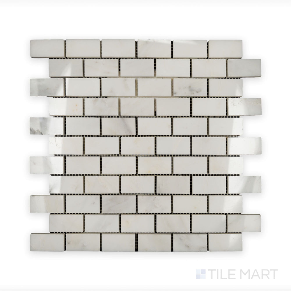 A sharp close-up of Oriental White Marble 1X2 Brick Polished Mosaic, displaying its smooth, glossy texture and crisp edges.
