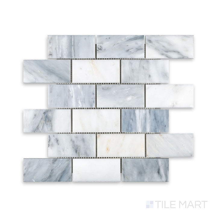 A close-up of Oriental White Marble 2X4 Brick Honed Mosaic, displaying its soft, matte finish and precisely arranged rectangular tiles.